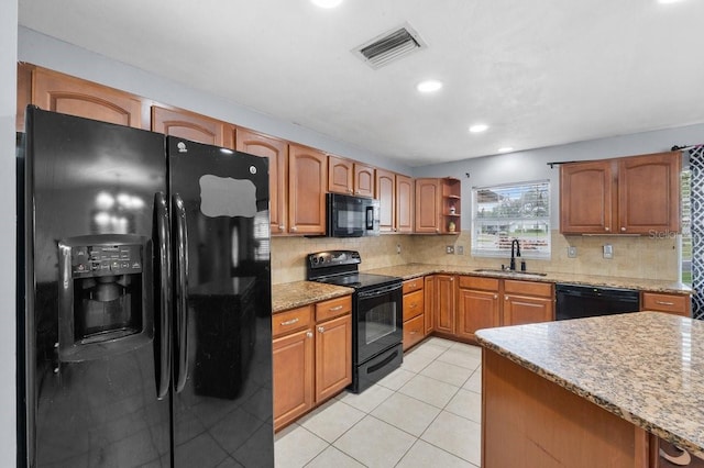 320 Boger Blvd S, Lakeland, FL 33803 - kitchen featuring black appliances, a sink, decorative backsplash, light stone countertops, and recessed lighting