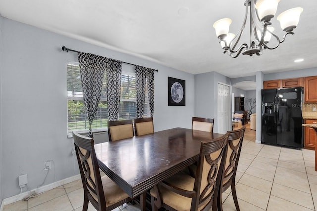 320 Boger Blvd S, Lakeland, FL 33803 - dining area with a chandelier, arched walkways, light tile patterned floors, and baseboards