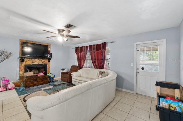 320 Boger Blvd S, Lakeland, FL 33803 - living room featuring light tile patterned floors, ceiling fan, a stone fireplace, and baseboards