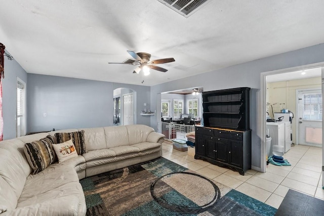 320 Boger Blvd S, Lakeland, FL 33803 - living room featuring a ceiling fan, light tile patterned flooring, arched walkways, and healthy amount of natural light