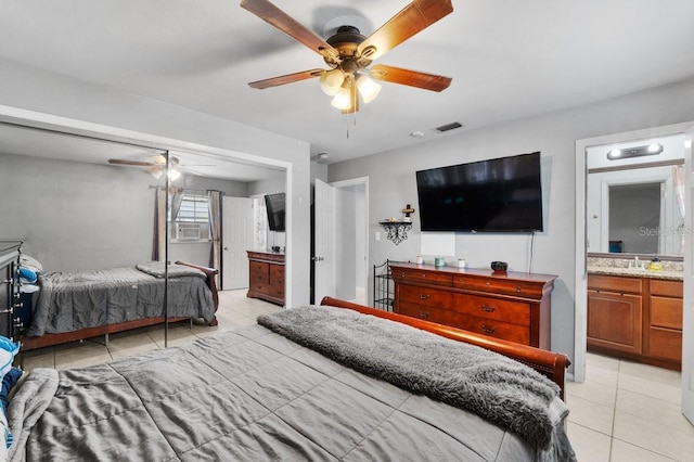 320 Boger Blvd S, Lakeland, FL 33803 - bedroom with light tile patterned floors, connected bathroom, a sink, and ceiling fan