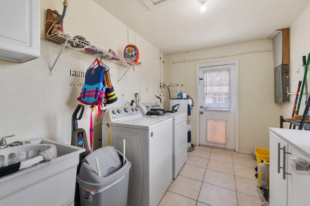 320 Boger Blvd S, Lakeland, FL 33803 - laundry room with cabinet space, washing machine and dryer, electric panel, light tile patterned floors, and water heater