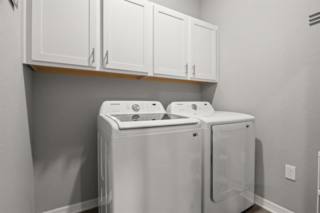 1081 Sandpiper Loop, Winter Haven, FL 33881 - washroom with cabinet space, washer and dryer, and baseboards