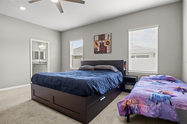 1081 Sandpiper Loop, Winter Haven, FL 33881 - bedroom featuring light colored carpet, baseboards, connected bathroom, and ceiling fan