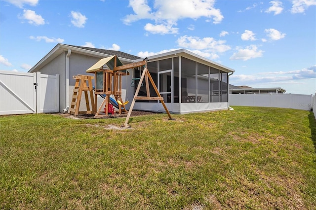 1081 Sandpiper Loop, Winter Haven, FL 33881 - back of property with a sunroom, a gate, and a playground