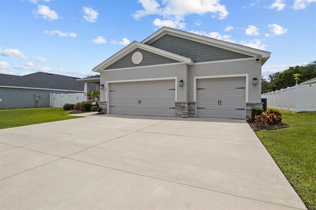 1081 Sandpiper Loop, Winter Haven, FL 33881 - view of front facade featuring stone siding, stucco siding, a garage, and driveway