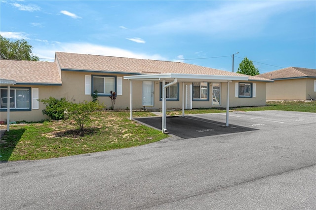 299 Winter Ridge Blvd Unit 299, Winter Haven, FL 33881 - ranch-style house with uncovered parking, a shingled roof, and stucco siding