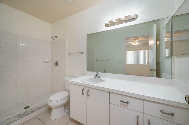 299 Winter Ridge Blvd Unit 299, Winter Haven, FL 33881 - bathroom featuring toilet, a tile shower, vanity, tile patterned floors, and a ceiling fan