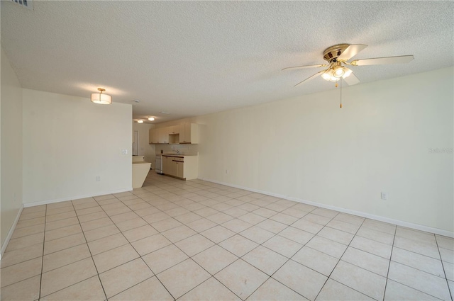 299 Winter Ridge Blvd Unit 299, Winter Haven, FL 33881 - unfurnished living room featuring a ceiling fan, a textured ceiling, baseboards, and a sink