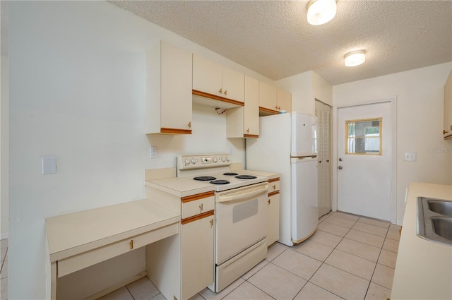 299 Winter Ridge Blvd Unit 299, Winter Haven, FL 33881 - kitchen featuring white appliances, a textured ceiling, light countertops, and light tile patterned floors