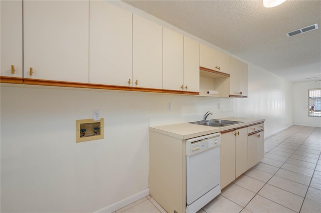 299 Winter Ridge Blvd Unit 299, Winter Haven, FL 33881 - kitchen featuring white dishwasher, a sink, a textured ceiling, light countertops, and light tile patterned flooring