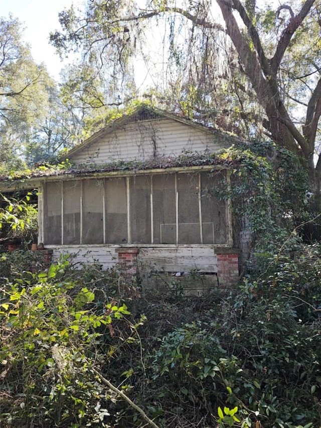 148 NE Williams St, Lake City, FL 32055 - view of home's exterior featuring a sunroom