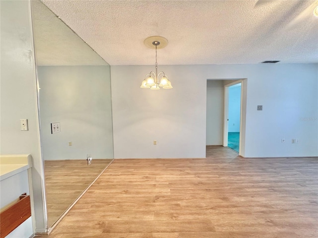 254 Winter Ridge Blvd Unit 254, Winter Haven, FL 33881 - unfurnished dining area with wood finished floors, a chandelier, and a textured ceiling