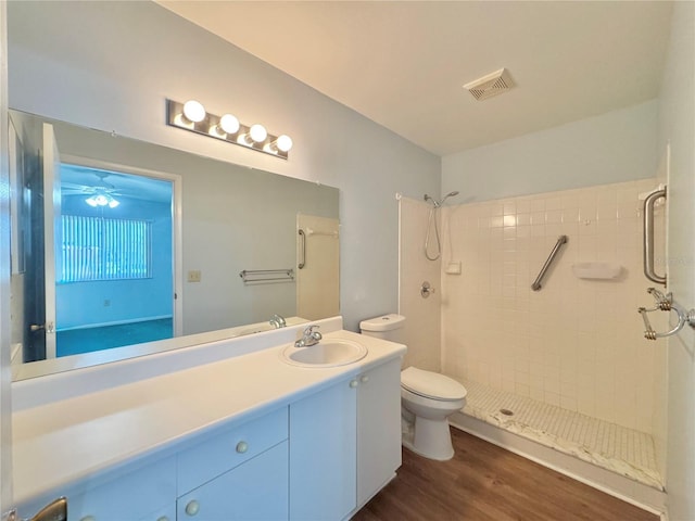 254 Winter Ridge Blvd Unit 254, Winter Haven, FL 33881 - full bathroom featuring toilet, wood finished floors, a stall shower, and vanity