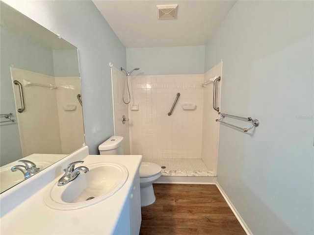 254 Winter Ridge Blvd Unit 254, Winter Haven, FL 33881 - bathroom featuring toilet, a tile shower, wood finished floors, and vanity