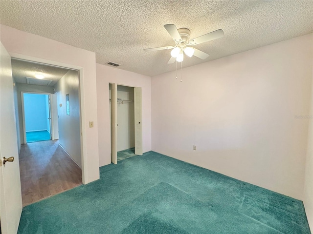 254 Winter Ridge Blvd Unit 254, Winter Haven, FL 33881 - unfurnished bedroom featuring carpet floors, a closet, ceiling fan, attic access, and a textured ceiling