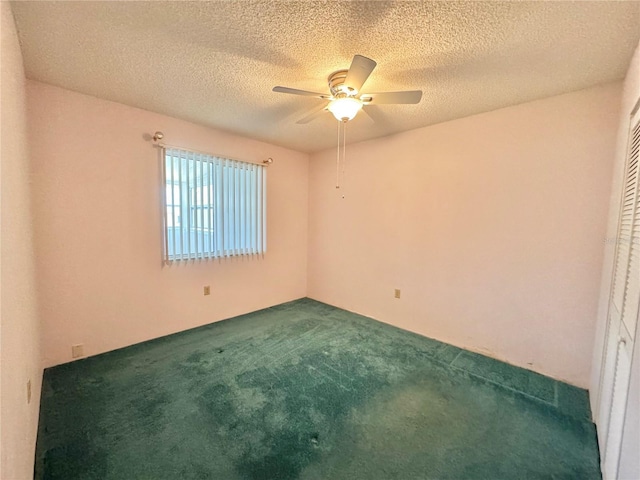 254 Winter Ridge Blvd Unit 254, Winter Haven, FL 33881 - spare room featuring dark colored carpet, ceiling fan, and a textured ceiling