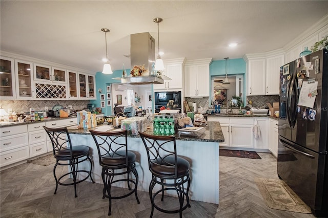2213 W Pilaklakaha Ave, Auburndale, FL 33823 - kitchen featuring black appliances, decorative backsplash, a kitchen breakfast bar, and recessed lighting