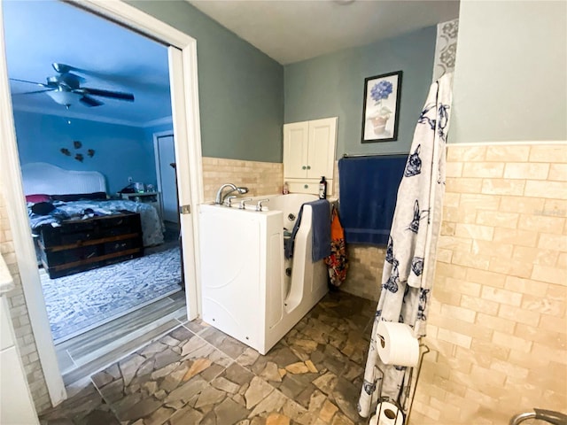 2213 W Pilaklakaha Ave, Auburndale, FL 33823 - laundry room featuring ceiling fan, wainscoting, and stone finish floors