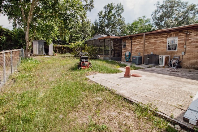 2213 W Pilaklakaha Ave, Auburndale, FL 33823 - view of yard featuring a sunroom, a patio, and central AC unit