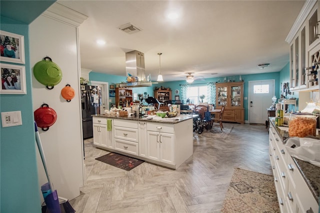 2213 W Pilaklakaha Ave, Auburndale, FL 33823 - kitchen with black refrigerator with ice dispenser, a ceiling fan, white cabinetry, glass insert cabinets, and hanging light fixtures