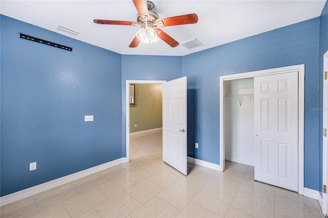 1553 Wright Dr, Lakeland, FL 33805 - unfurnished bedroom with a textured wall, a closet, a ceiling fan, and baseboards