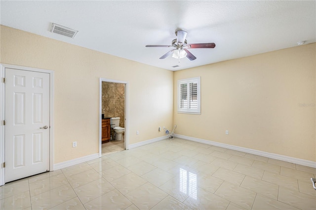 1553 Wright Dr, Lakeland, FL 33805 - unfurnished bedroom featuring baseboards, ensuite bath, and ceiling fan