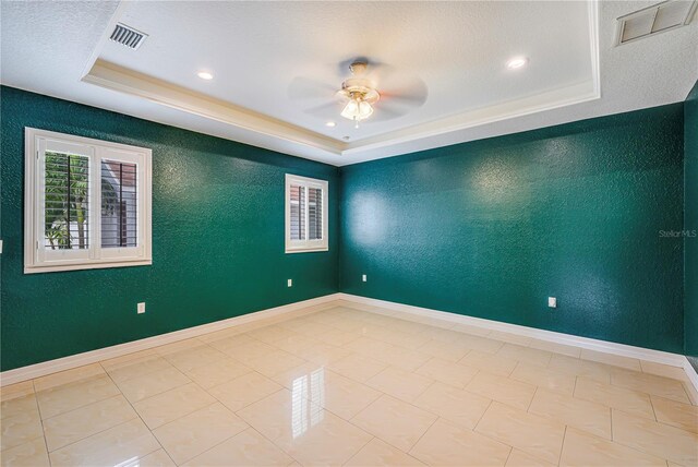 1553 Wright Dr, Lakeland, FL 33805 - tiled empty room featuring a raised ceiling, ceiling fan, a textured wall, baseboards, and recessed lighting