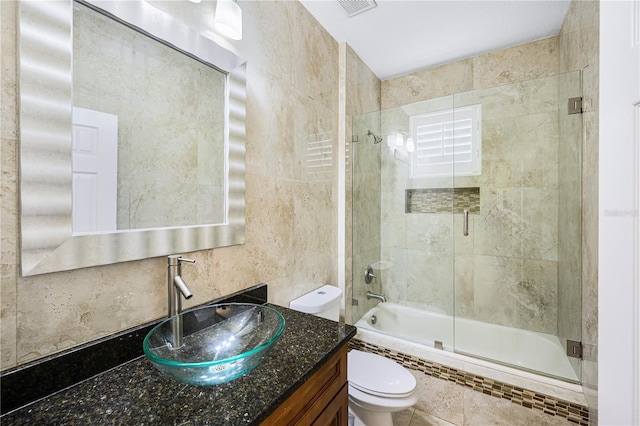 1553 Wright Dr, Lakeland, FL 33805 - full bath with toilet, tiled shower / bath combo, vanity, and tile walls