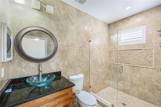 1553 Wright Dr, Lakeland, FL 33805 - full bathroom featuring vanity, a shower stall, toilet, tile walls, and decorative backsplash