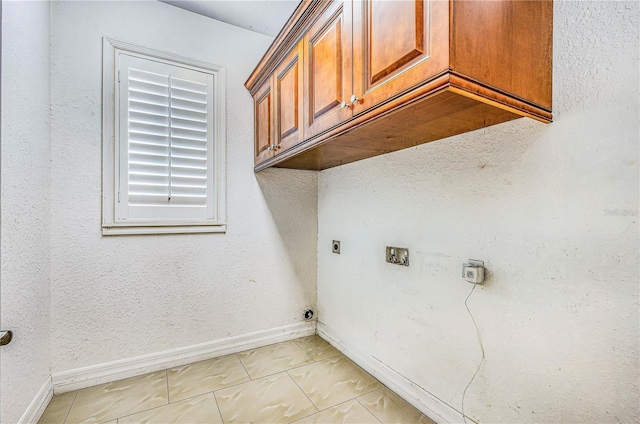 1553 Wright Dr, Lakeland, FL 33805 - laundry area featuring hookup for an electric dryer, cabinet space, washer hookup, and baseboards