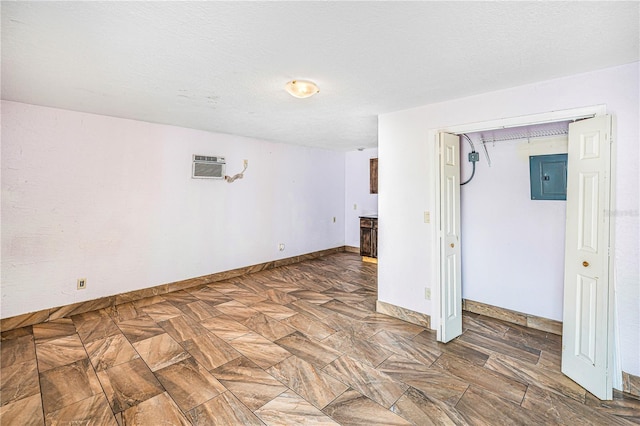 1553 Wright Dr, Lakeland, FL 33805 - unfurnished room featuring electric panel, a wall unit AC, and baseboards