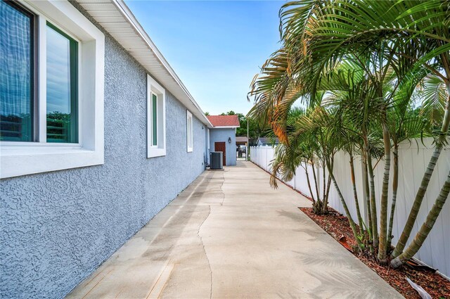1553 Wright Dr, Lakeland, FL 33805 - view of property exterior with stucco siding, central air condition unit, and a fenced backyard