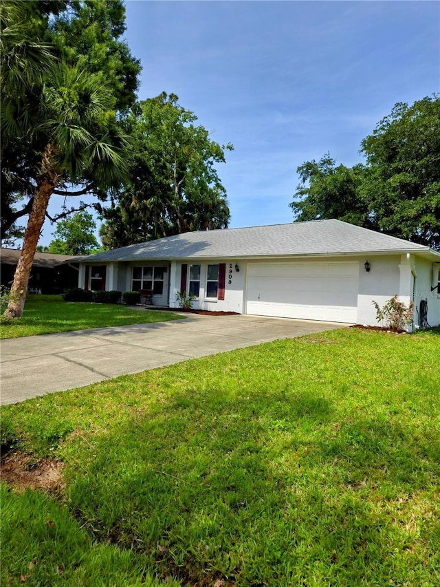 2909 Pine Tree Dr, Edgewater, FL 32141 - ranch-style home featuring driveway, an attached garage, a front lawn, and stucco siding