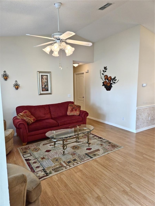 2909 Pine Tree Dr, Edgewater, FL 32141 - living room with vaulted ceiling, wood finished floors, a ceiling fan, and baseboards