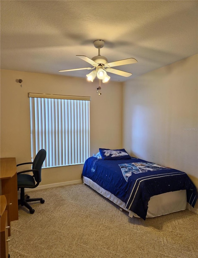 2909 Pine Tree Dr, Edgewater, FL 32141 - carpeted bedroom featuring a ceiling fan, baseboards, and a textured ceiling