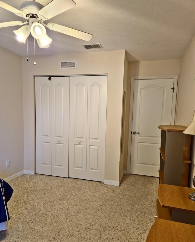 2909 Pine Tree Dr, Edgewater, FL 32141 - bedroom with carpet, baseboards, a closet, and a textured ceiling