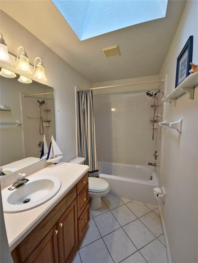 2909 Pine Tree Dr, Edgewater, FL 32141 - full bath featuring a skylight, toilet, tile patterned flooring, shower / bath combination with curtain, and vanity