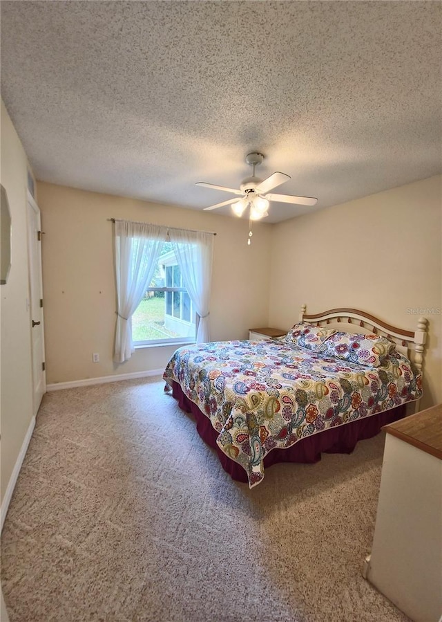 2909 Pine Tree Dr, Edgewater, FL 32141 - bedroom with a textured ceiling, carpet, a ceiling fan, and baseboards