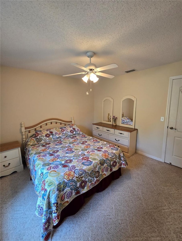 2909 Pine Tree Dr, Edgewater, FL 32141 - carpeted bedroom with a textured ceiling and a ceiling fan