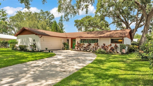 527 Duchess Dr, Lakeland, FL 33803 - single story home featuring a garage, driveway, a front lawn, and stucco siding