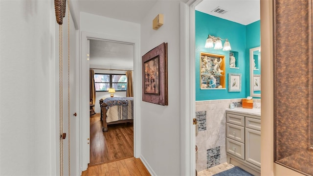 527 Duchess Dr, Lakeland, FL 33803 - hall featuring light wood-type flooring and tile walls