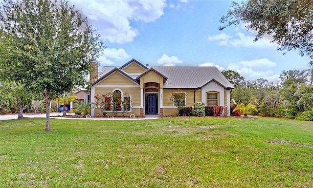 540 Phillips Rd, Sebring, FL 33875 - view of front facade with a front lawn, a chimney, and metal roof