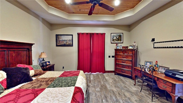 540 Phillips Rd, Sebring, FL 33875 - bedroom with wooden ceiling, a tray ceiling, wood finished floors, baseboards, and a ceiling fan