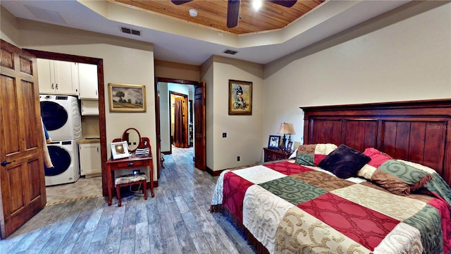 540 Phillips Rd, Sebring, FL 33875 - bedroom with stacked washer / drying machine, a raised ceiling, wood ceiling, wood finished floors, and baseboards
