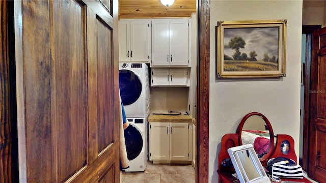 540 Phillips Rd, Sebring, FL 33875 - laundry room with cabinet space, stacked washer / dryer, and light tile patterned floors