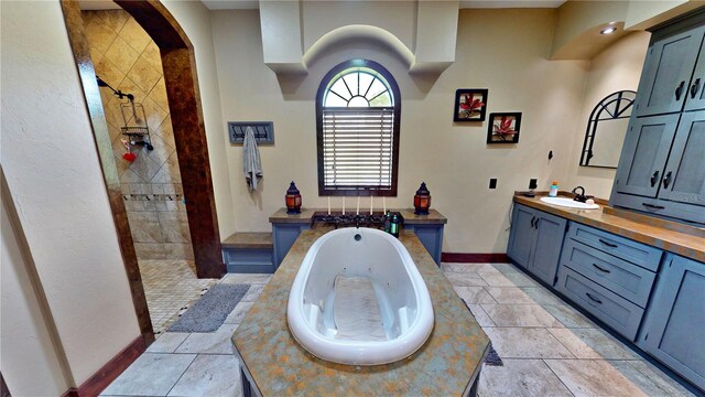 540 Phillips Rd, Sebring, FL 33875 - full bath featuring a whirlpool tub, vanity, a walk in shower, baseboards, and tile patterned floors