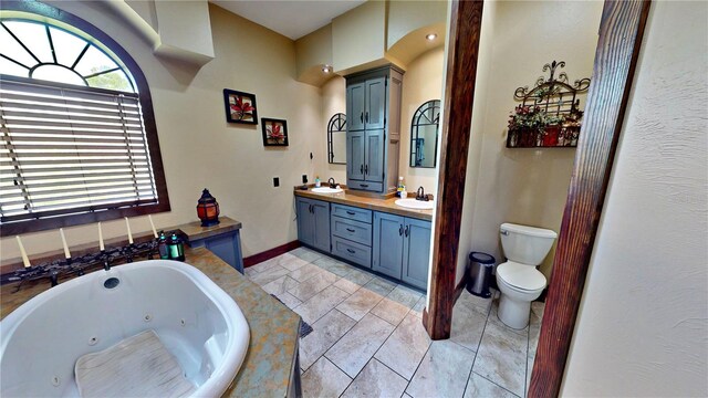540 Phillips Rd, Sebring, FL 33875 - bathroom with double vanity, a tub with jets, toilet, and baseboards