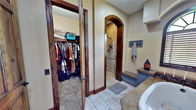 540 Phillips Rd, Sebring, FL 33875 - bathroom featuring a whirlpool tub, a tile shower, a spacious closet, and tile patterned flooring
