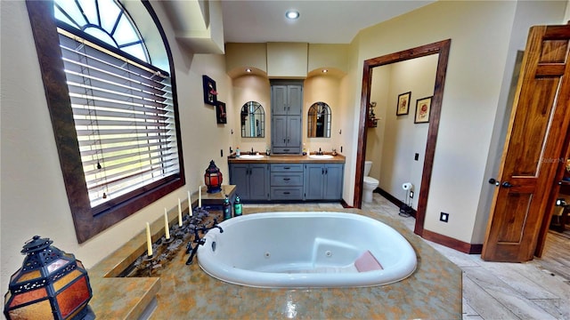 540 Phillips Rd, Sebring, FL 33875 - full bath with toilet, double vanity, a tub with jets, and healthy amount of natural light